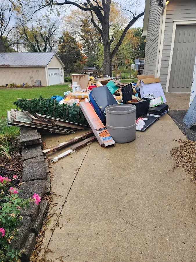 Dumpster being loaded with debris for Estate Cleanout Dumpster Rental in Clifton